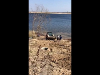 a man caught a pike with a tractor bucket